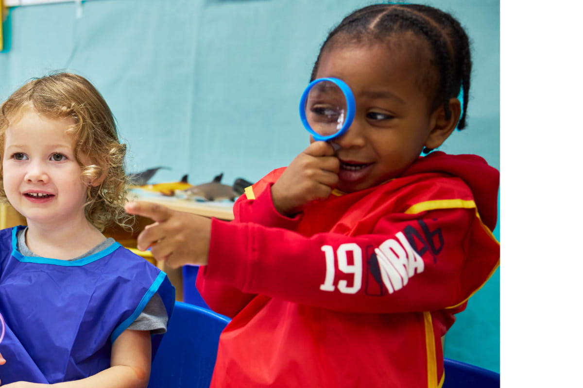 preschool student with magnifying glass