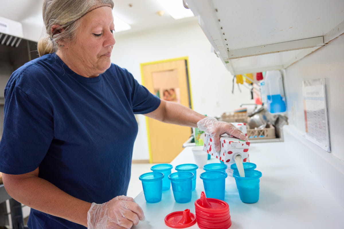 teacher pouring milk