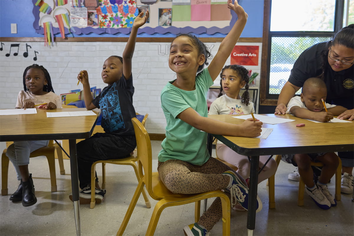 kindergarteners raising hands